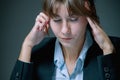 Portrait of unhappy and depressed business woman working overtime in office and having a headache from emotional stress Royalty Free Stock Photo