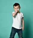Portrait of unhappy sad bored kid boy leaning head on palm looking with upset Royalty Free Stock Photo