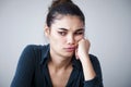 Portrait of unhappy woman on gray background