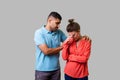 Portrait of unhappy worried young couple in casual wear standing together. isolated on gray background