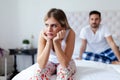 Portrait of unhappy young couple in bedroom Royalty Free Stock Photo