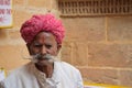 Portrait of an unidentified aged indian man with mustaches and traditional red turban in Jaisalmer, Rajasthan - India