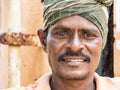 Portrait of unidentified Indian worker looking at camera with smile. Rural people daily lifestyle of India