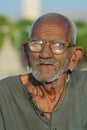 Portrait of an unidentified senior hindu man wearing glasses at the street in Jaipur, India.