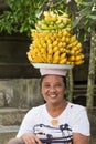 Portrait of unidentified woman together with bananas on her head on the market Royalty Free Stock Photo