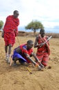Portrait of unidentified young Maasai warriors shows how to make fire Royalty Free Stock Photo