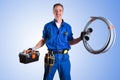 Portrait of uniformed plumber with work tools and isolated background Royalty Free Stock Photo