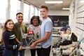 Portrait Of University Students Carrying Machine In Science Robotics Or Engineering Class