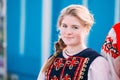 Portrait of unknown beautiful young woman girl in national folk clothes at Celebration of Maslenitsa Shrovetide holiday