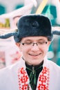 Portrait of unknown happy young man in funny national russian folk clothes