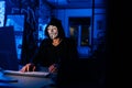 Portrait of unrecognizable dangerous hacker man in anonymous mask starting breaking computer system and typing password