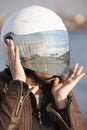 Portrait of unrecognizable European female motorcyclist with road reflection in her mirrored tinted visor of a helmet, collage