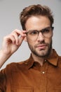 Portrait of unshaven young man posing at camera and looking aside