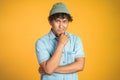 unsure asian young man thinking on isolated background