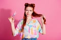 Portrait of unsure nice woman wear print shirt hand hold foxy hair scissors think to make tail shorter isolated on pink Royalty Free Stock Photo