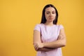 Portrait of unsure young girl with crossed arms. Royalty Free Stock Photo