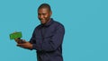 Portrait of upbeat security staff member showing green screen smartphone