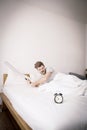 Portrait upset angry with baseball hit young man screaming at alarm clock on bedroom. Royalty Free Stock Photo