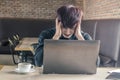 Portrait of an upset businessman at desk in cafe. Businessman being depressed by working in cafe.