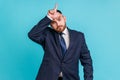 Portrait of upset disappointed young adult businessman with beard in dark suit standing, showing looser gesture with hand on Royalty Free Stock Photo