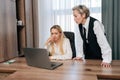 Portrait of upset female employee being scolded by boss for coming late at office. Frustrated manager feeling guilty Royalty Free Stock Photo