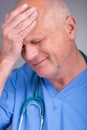 Upset / distraught doctor wearing surgical mask and stethoscope. Royalty Free Stock Photo