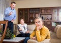 Portrait of upset girl scolded by parents at home