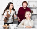 Upset girl scolded by mother and grandma