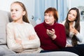 Upset girl scolded by mother and grandma