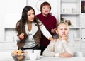 Upset girl scolded by mother and grandma