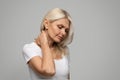 Portrait of upset mature woman suffering neck pain and strain Royalty Free Stock Photo