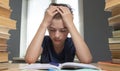 Portrait of upset schoolboy looking at textbook with homework