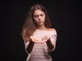 Sad woman holding tangled hair on the black background. Tuft of hair on a girl`s hand. Hair loss concept. Copy space. Royalty Free Stock Photo