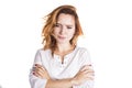 Portrait of an upset young casual brunette woman standing with arms folded isolated over white background Royalty Free Stock Photo