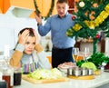 Portrait upset young man quarreling with wife during cooking Royalty Free Stock Photo