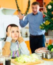 Portrait upset young man quarreling with wife during cooking Royalty Free Stock Photo