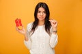 Portrait of an upset young woman holding small gift box Royalty Free Stock Photo