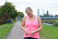 Upset young woman looking at her belly fat