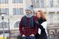 Urban people on urban background. Man and woman looking ahead. Couple waiting for city bus. Woman standing behind man`s back. Royalty Free Stock Photo