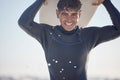 Portrait, vacation and man holding surfboard at the beach, sea or ocean with a smile and is happy on a summer day. Man Royalty Free Stock Photo