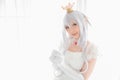 Portrait of vampire dracula young woman dress in white tone room halloween concept