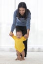 Portrait in vertical asian mom are leader hand with baby child walking both of them smile and look happy with look at camera with Royalty Free Stock Photo
