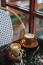 Coffee Latte and Matcha Latte on a black marble table near the window Royalty Free Stock Photo