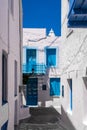 Portrait vertical view of Plaka Town street on Milos Island, Greece with no people. Traditional architecure with whitewashed house