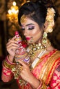 Portrait of very beautiful Indian bride holding traditional wooden sindur or sindoor box in hand, Wedding symbol sindoor box