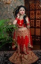 Portrait of very beautiful sexy indian bride in red lehenga showing navel. Non Bengali bridal portrait Royalty Free Stock Photo