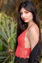 Portrait of very beautiful young attractive woman wearing red outfit with black jacket posing fashionable in a blurred background Royalty Free Stock Photo