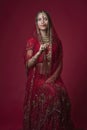 Portrait of very beautiful young Indian bride in luxurious bridal costume with makeup and heavy jewellery Royalty Free Stock Photo