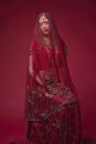 Portrait of very beautiful young Indian bride in luxurious bridal costume with makeup and heavy jewellery Royalty Free Stock Photo