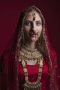 Portrait of very beautiful young Indian bride in luxurious bridal costume with makeup and heavy jewellery Royalty Free Stock Photo